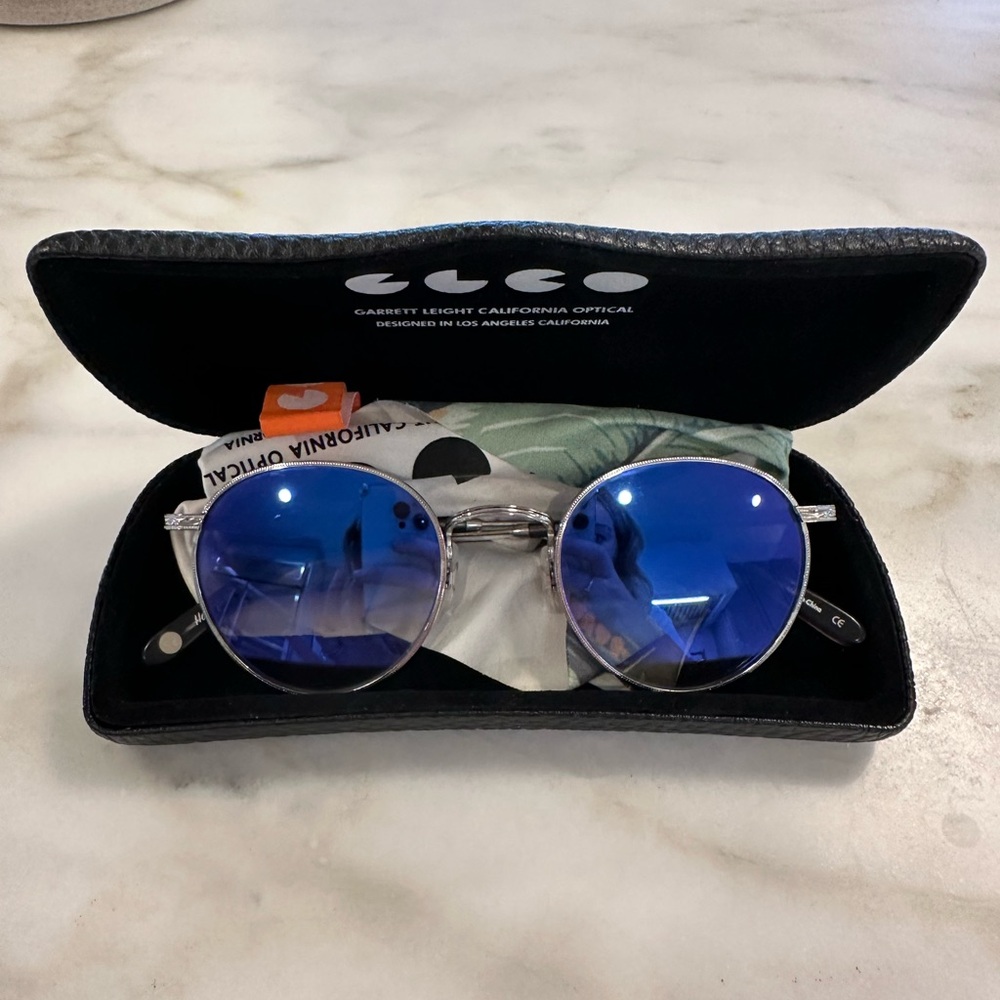 Garrett Leight round mirrored sunglasses.